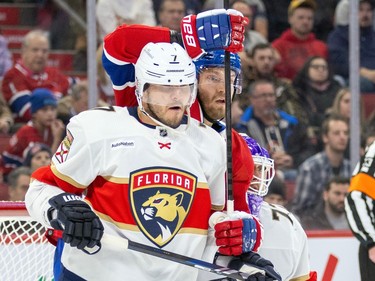 Montreal Canadiens' Joel Armia has his stick around the shoulder of Florida Panthers Dmitry Kulikov