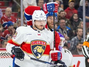 Montreal Canadiens' Joel Armia has his stick around the shoulder of Florida Panthers Dmitry Kulikov