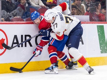Montreal Canadiens' Tanner Pearson is pinned against the boards by Florida Panthers' Niko Mikkola