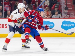 Montreal Canadiens' Christian Dvorak is knocked off-stride by Florida Panthers' Niko Mikkola