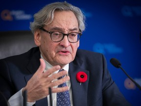 A man gestures during a press conference.