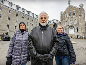 Three people stand outside the former Hôtel-Dieu hospital