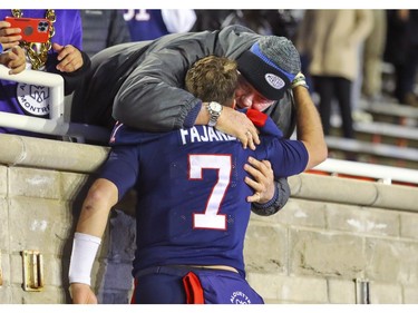 Alouettes quarterback Cody Fajardo hugs his father, Tim, following Canadian Football League East Division semifinal playoff game against the Hamilton Tiger-Cats in Montreal on Saturday, Nov. 4, 2023.