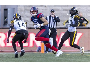 Alouettes Austin Mack crosses the goal line for a touchdown between Hamilton Tiger-Cats Dexter Lawson Jr. and Richard Leonard during second half of Canadian Football League East Division semifinal playoff game against the Hamilton Tiger-Cats in Montreal on Saturday, Nov. 4, 2023.