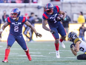 Alouettes linebacker Darnell Sankey spins away from Tiger-Cats reciever Kiondré Smith after intercepting a pass, as Als' Avery Williams, left, looks for someone to block during game last week at Molson Stadium.