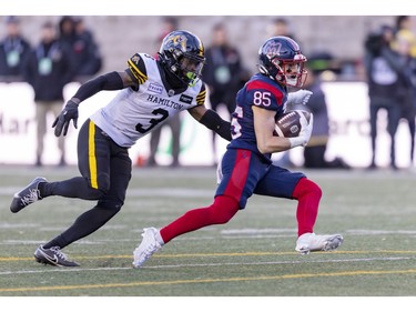 Alouettes receiver Tyler Snead runs from Hamilton Tiger-Cats defensive back Kenneth George Jr. for a first down during second half of Canadian Football League East Division semifinal playoff game against the Hamilton Tiger-Cats in Montreal on Saturday, Nov. 4, 2023.