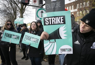 Signs saying "Strike" and "together" seen on a picket line