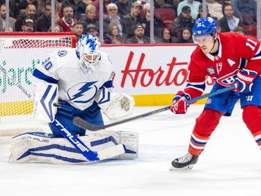 Canadiens Brendan Gallagher tries to tip a shot in front of Tampa Bay Lightning goalie Matt Tomkins