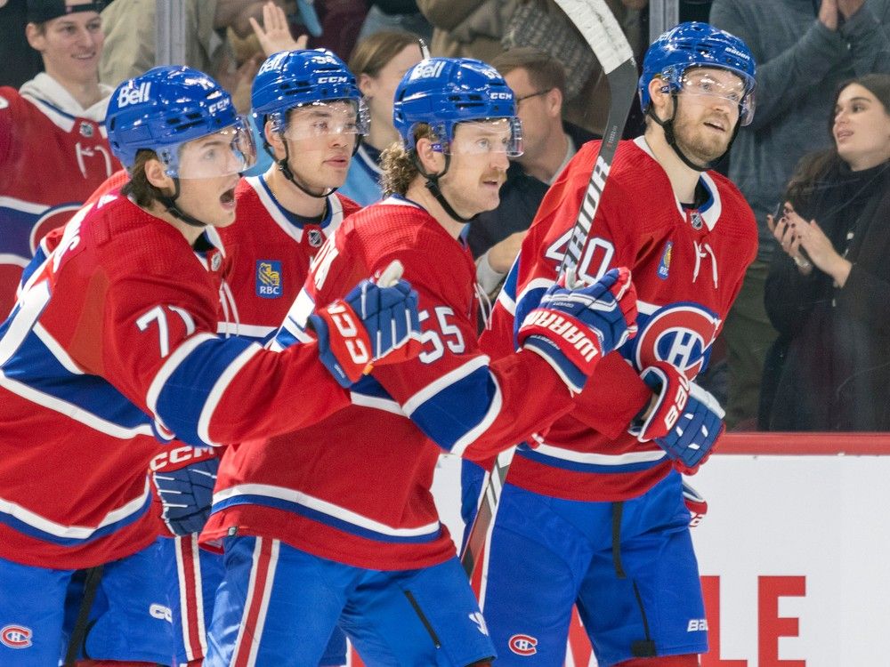 Four Canadiens skate together on the ice