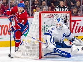 Canadiens' Mike Matheson circles behind Lightning goalie Matt Tomkins's net during first-period action Tuesday night at the Bell Centre.