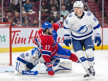 Canadiens' Josh Anderson falls over Tampa Bay Lightning goalie Matt Tomkins as Mikhail Sergachev skates by