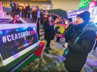Ellen Gabriel speaks to a crowd with a poster reading 'Ceasefire now' prominent