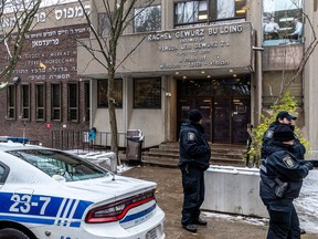 Police patrol outside a Jewish school after a shot was fired at its door.