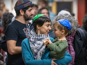Corey Balsam and Bérengére Ruet brought their son Elias to a Shabbat in solidarity with people in Gaza that was organized by Independent Jewish Voices in Montreal on Friday, Nov. 10, 2023.