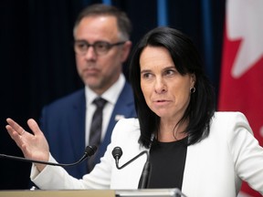 Valérie Plante speaks at a podium with Luc Rabouin behind her