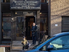 A parent watches from his car as his child enters the Medicoff-Schneiderman Elementary School in Montreal on Monday November 13, 2023. Dave Sidaway / Montreal Gazette