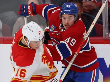 Montreal Canadiens' Rafael Harvey-Pinard (49) with Calgary Flames' Nikita Zadorov (16)