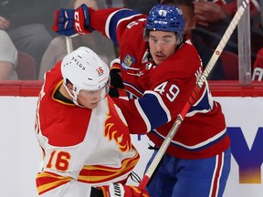 Canadiens' Rafael Harvey-Pinard, right, tussles with Flames' Nikita Zadorov during game last week at the Bell Centre.