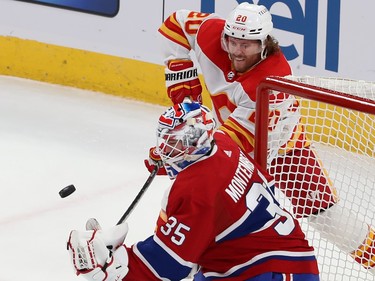 Calgary Flames' Blake Coleman (20) tries to get to a rebound next to Canadiens goaltender Sam Montembeault