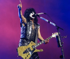 Paul Stanley of Kiss holds up his hand while performing at the Bell Centre.