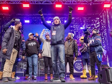 Anthony Calvillo raises his hands in the air while looking out at the crowd from the stage