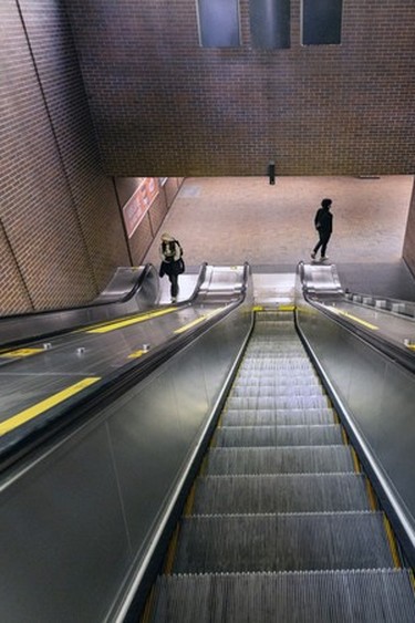 A downward view of the long escalator at the Lucien-L'Allier métro station.