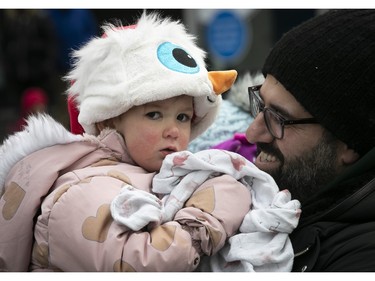 A little apprehensive at the start of the Montreal Santa Claus parade, two-year-old Ariel Sabounjian waits with dad Robert Sabounjian on Saturday, Nov. 25, 2023.
