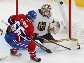 The puck is visible high in the net with Montreal Canadiens' Jesse Ylonen in front of Vegas goaltender Adin Hill
