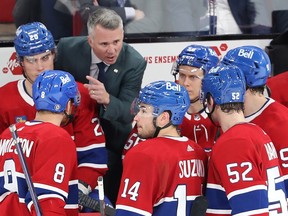 Montreal Canadiens head coach Martin St. Louis speaks to his players at the bench