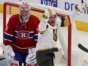 Vegas Golden Knights' Mark Stone raises his arms in celebration in front of Montreal Canadiens goaltender Cayden Primeau and the net