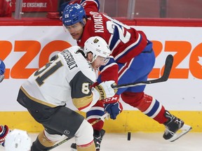 Canadiens' Johnathan Kovacevic skates in the opposite direction as Vegas Golden Knights' Jonathan Marchessault near the boards