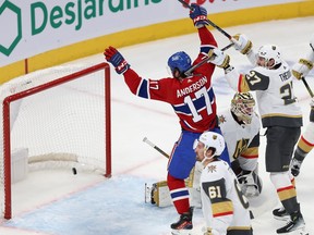 Montreal Canadiens' Josh Anderson lifts his arms in the air as a puck sits in the net behind Vegas's goaltender