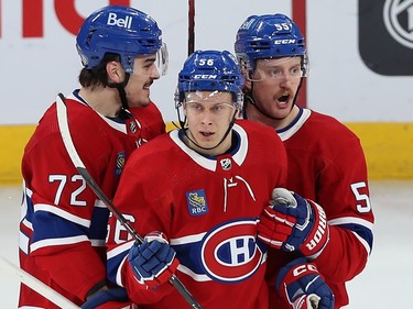 Three Canadiens players in a tight group
