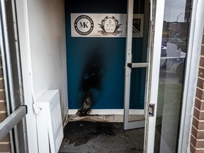 Burn marks can be seen on the door of a firebombed building.