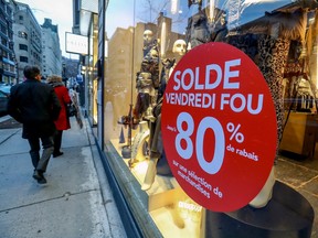 Black Friday deals are advertised on a storefront window on de la Montagne St. in Montreal in 2019.