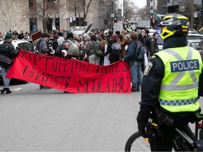 Montreal police watch a group of Concordia students protest Quebec's tuition hike outside the Hall Building.