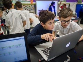 Students look at a computer during a science class at Edinburgh School, Tuesday, December 17, 2019.