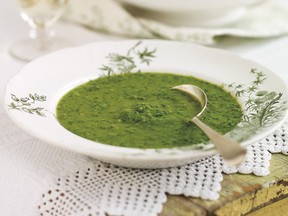 Green pea soup in a white bowl with small green flowers