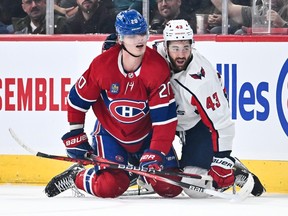 Canadiens' Juraj Slafkovsky is seen on his knees on the ice with his helmet covering his eyes in front of Capitals' Tom Wilson, also on his knees, during game two weeks ago.
