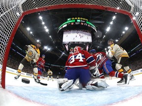 In a view from the back of the net, the puck is fired past Canadiens goalie Jake Allen during Saturday's 5-2 loss in Boston.