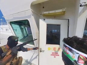 This handout screen grab captured from a video shows Yemen's Houthi fighters' takeover of the Galaxy Leader Cargo in the Red Sea coast off Hudaydah, on Nov.20, 2023 in the Red Sea, Yemen.