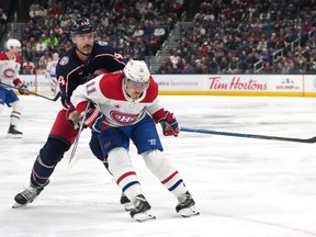 Erik Gudbranson #44 of the Columbus Blue Jackets battles Brendan Gallagher #11 of the Montreal Canadiens for position on the ice during the first period at Nationwide Arena on November 29, 2023 in Columbus, Ohio.