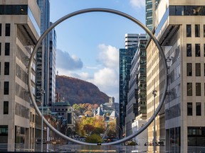Mount Royal is framed by buildings and the steel Ring installation