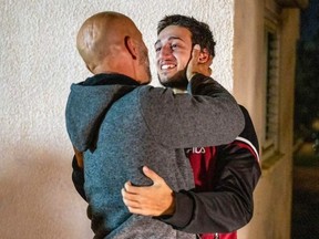 18-year-old former Israeli hostage Liam Or (right) reunited with his father