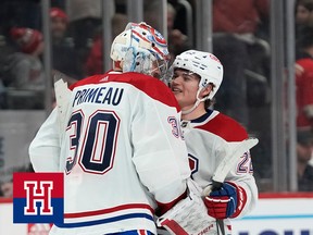 A goalie celebrates with a small forward after a hockey game