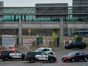 Canadian police cars are seen near the Rainbow Bridge border crossing into the U.S. in Niagara Falls, Ont., after a car exploded at a U.S.-Canada checkpoint on Nov. 22, 2023.