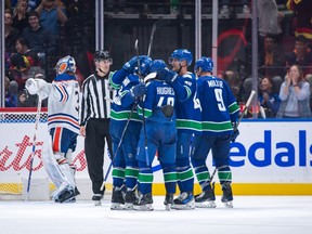 Brock Boeser #6 of the Vancouver Canucks is congratulated after scoring his third goal on Jack Campbell #36 of the Edmonton Oilers during the second period of their NHL game at Rogers Arena on October 11, 2023 in Vancouver, British Columbia, Canada.
