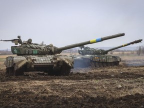 Ukrainian army tanks exercise as soldiers check the readiness of equipment for combat deployment at a military base in Zaporizhzhia region, Ukraine, Wednesday, Apr. 5, 2023. The chief of a First Nation community in northern Manitoba says one of the community's residents has died after going to fight in Ukraine.