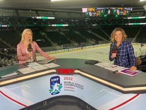Tessa Bonhomme, left, and Cheryl Pounder sit behind a desk holding TSN microphones at the 2022 World Junior Hockey Championship in Edmonton last year.