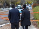 Young men look toward Yeshiva Gedola of Montreal on Deacon Rd. on Sunday, November 12, 2023, after gunshots were fired at the school.